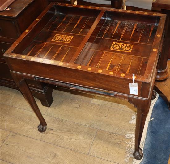 A George II mahogany backgammon table having reversible baize-lined top with counter wells and pull-out W.73cm